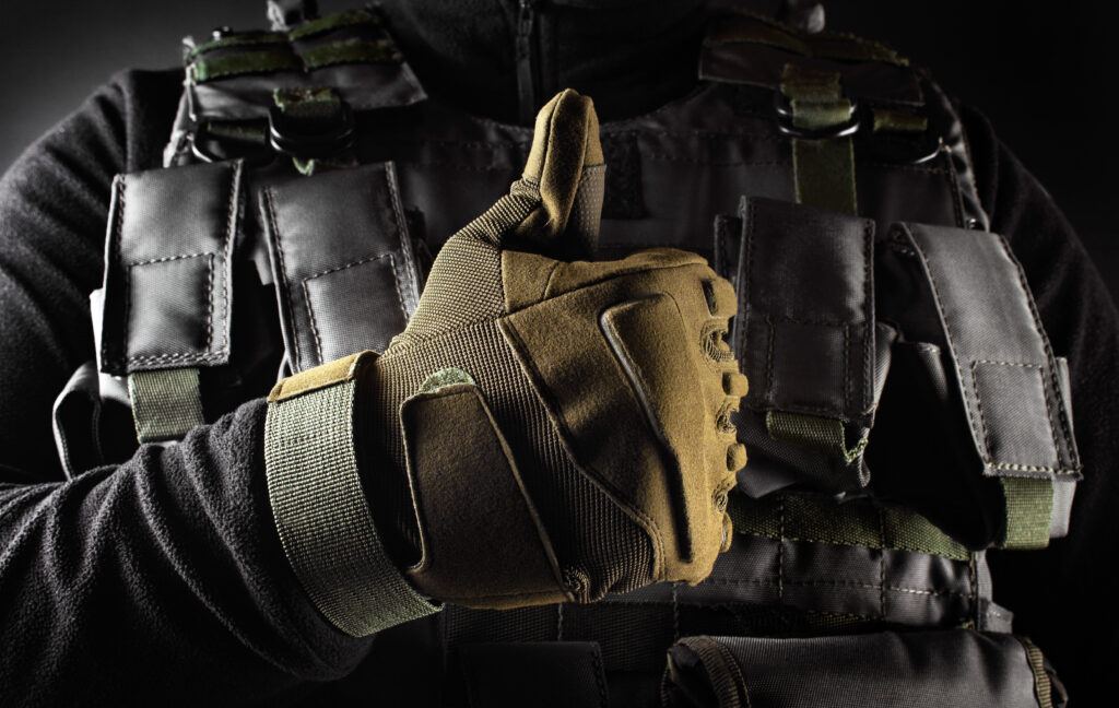 Soldier In Tactical Gloves Showing Like Front View Closeup.